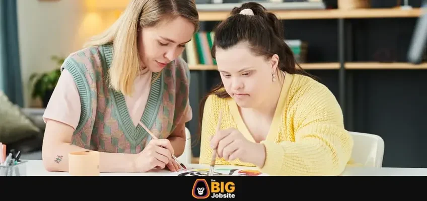 Woman teacher teaching with a girl having individual art therapy class