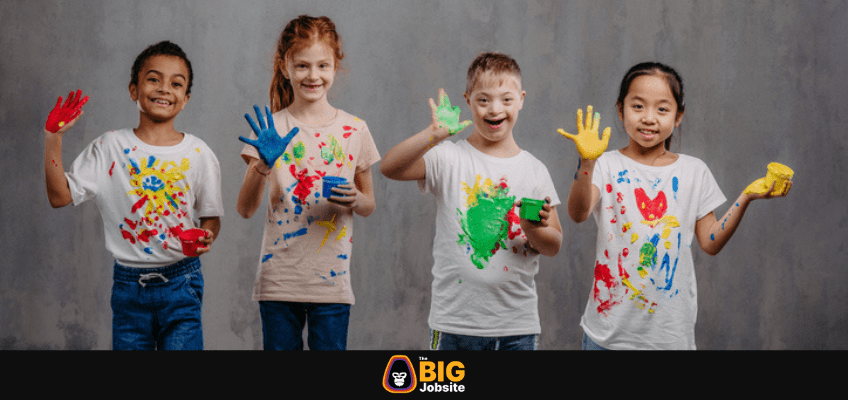 Portrait of happy kids with finger colours and painted t-shirts, studio shoot. stock photo